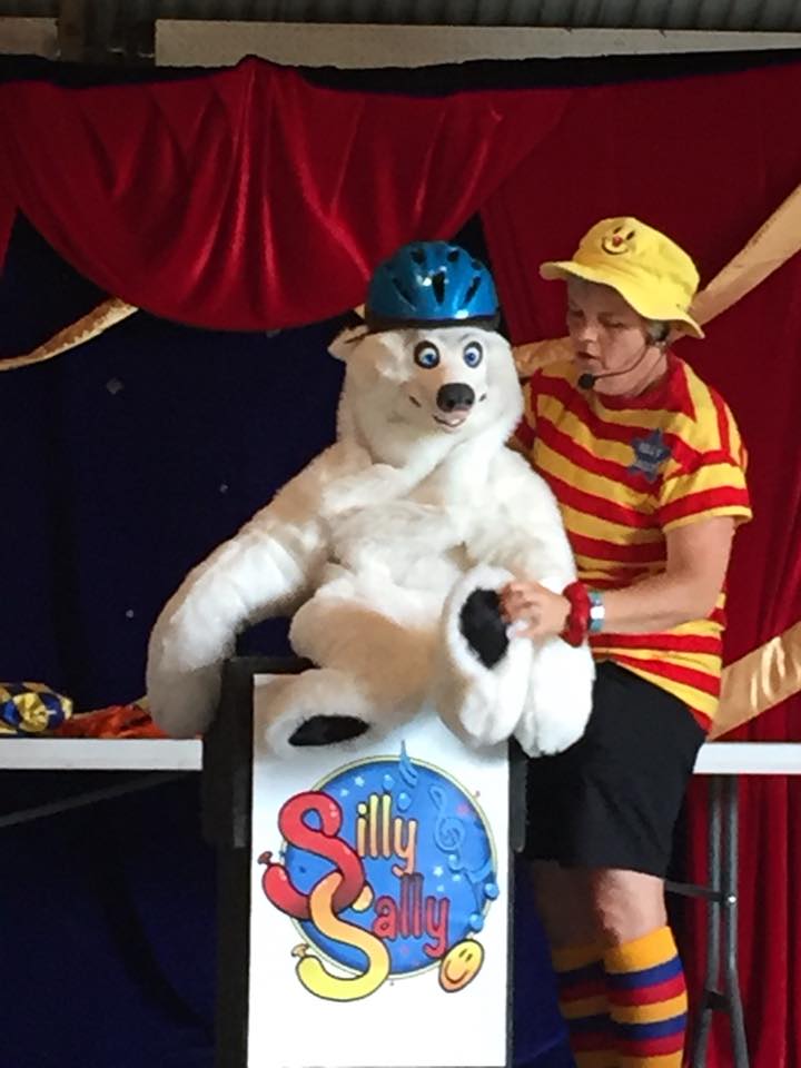 Sally on stage with ventriloguist puppet Snowflake